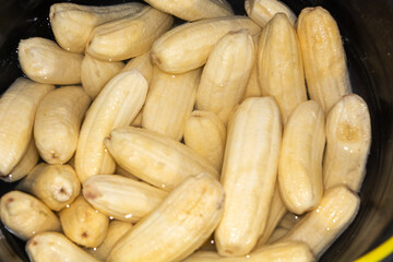 Close up of making a light snack of yellow banana chips