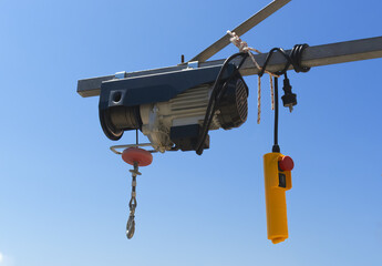 Electrical hoist on the  metal beam