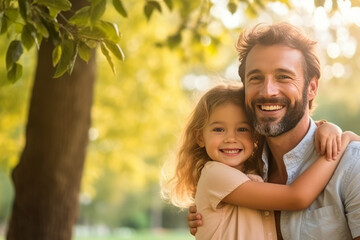 Fototapeta premium Portrait of a happy father and his little daughter in the park