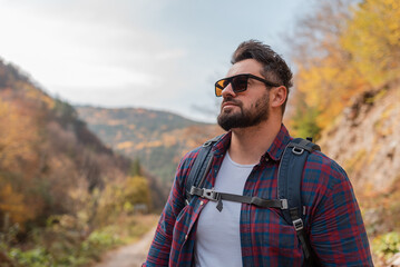 A handsome man hiker hiking in mountain forest adventure travel.