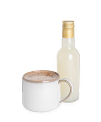 Bottle of delicious syrup and cup of coffee isolated on white