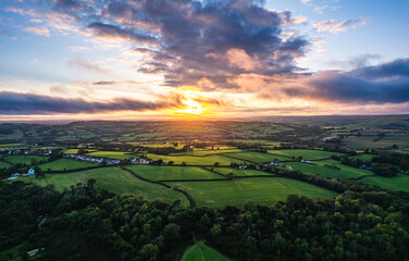 Sunset over Fields and Farms from a drone, Green Castle Wood, River Towy, Carmarthen, Wales, England
