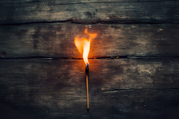 A close-up of a burning matchstick with fiery flames, representing danger and ignition. Perfect for fire safety and conceptual designs. - Powered by Adobe