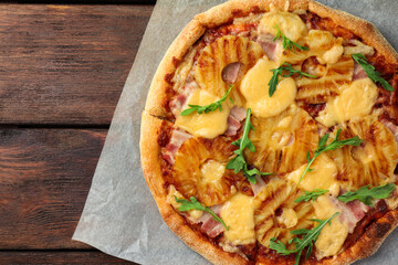 Delicious pineapple on wooden table, top view. Space for text