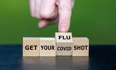 Wooden cubes form the expression 'get you flu and covid shot'.