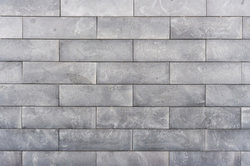 Old grey brick wall background. Texture of building wall.