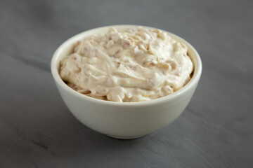 Homemade French Onion Dip in a Bowl on a gray background, side view.