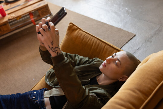 Gen Z female taking a selfie with a smartphone - Powered by Adobe