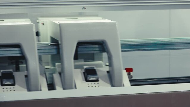 Industrial Printing on Material in the Modern Sewing Factory. Advanced Digital Printers Working to Add Beautiful Designs to Various Garments and Textiles. Sewing Factory Concept