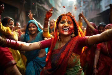 Fotobehang beautiful Indian women's dancing in street, Holi holiday © Olga