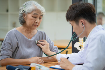Doctor listening to the heartbeat of a senior patient.
