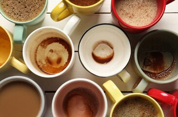 Many different cups with aromatic coffee and dirty ones on white wooden table, flat lay
