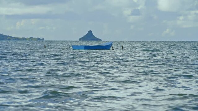 Row boat rocking alone  in water. 