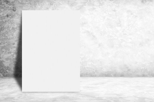 Blank Poster Leaning on White Grunge Concrete Wall Background Using for Product Presentation Backdrop.