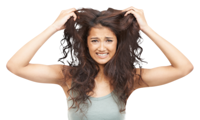 Hair care, crazy and portrait of young woman with frizzy, ugly and curly hairstyle for salon treatment. Upset, frustration and female model with messy hair isolated by a transparent png background.