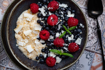 Oatmeal for breakfast with raspberries and blueberries