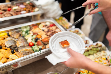 Self service buffet catering table with people in hotel