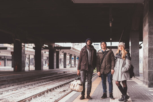 Three friends outdoor train platform waiting