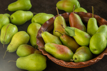 Parisian pear variety. Fruits on the table. Autumn harvest. Pears top view background. Green yellow red color pear. Vitamin vegan food.
