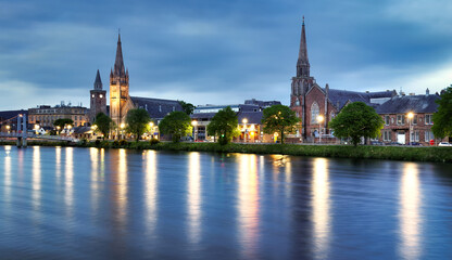 The view of the churches of Inverness on the Ness River, Scotland, UK at dramatic sunrise with...