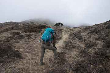 Woman hiker hiking at mountain top in tibet