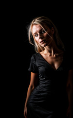 Fototapeta na wymiar photo of woman wearing a black dress on black background, generative AI