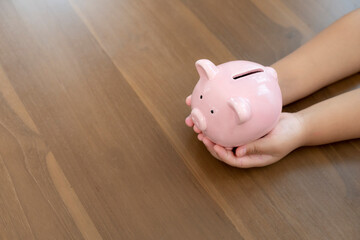 Young girl saving money at home