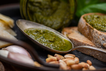 Old silver spoon with homemade pesto