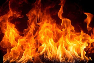 Fototapeta premium Blaze of fire on a black background, fire texture, fire burning, orange and yellow flames