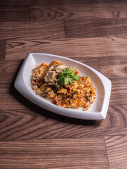 local traditional chinese stir wok fried big fresh oyster seafood with crispy chicken egg omelette in plate on wood table asian restaurant banquet cuisine halal food menu