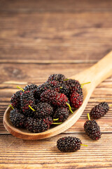 Ripe fresh blackberry fruits on the table.