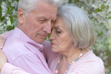 Portrait of sad senior couple in the park