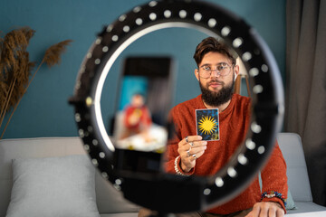 Fortune teller blogger with ring light and tarot cards to prediction future. Astrologist blogger...