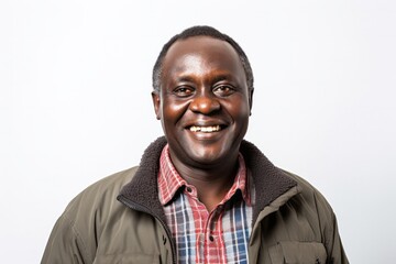 Obraz premium portrait of a confident Kenyan man in his 50s wearing a chic cardigan against a white background