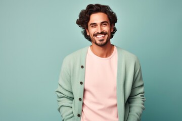 Obraz premium portrait of a confident Mexican man in his 20s wearing a chic cardigan against a pastel or soft colors background