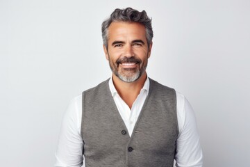 portrait of a confident Mexican man in his 40s wearing a chic cardigan against a white background