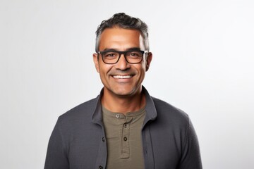 Obraz premium portrait of a confident Mexican man in his 40s wearing a chic cardigan against a white background