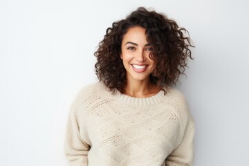 Fototapeta premium portrait of a confident Mexican woman in her 30s wearing a cozy sweater against a white background