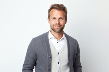 portrait of a confident Polish man in his 30s wearing a chic cardigan against a white background