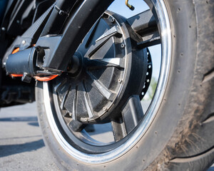Fototapeta premium Close-up of the rear wheel with the engine of an electric motorcycle.