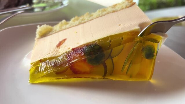Piece of fruit cake with peach, jello and vanilla mousse. High quality 4k footage