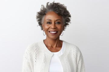 medium shot portrait of a confident Kenyan woman in her 50s wearing a chic cardigan against a white background - obrazy, fototapety, plakaty