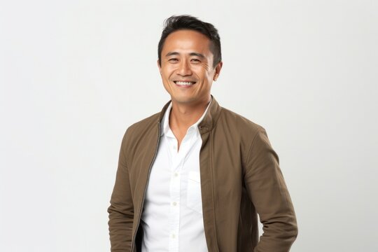 Portrait of a confident Filipino man in his 40s wearing a chic cardigan against a white background