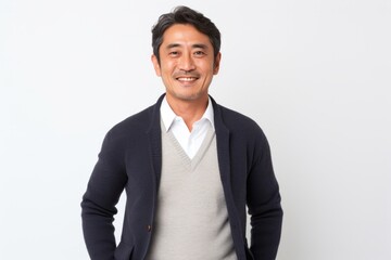 Portrait of a confident Japanese man in his 40s wearing a chic cardigan against a white background