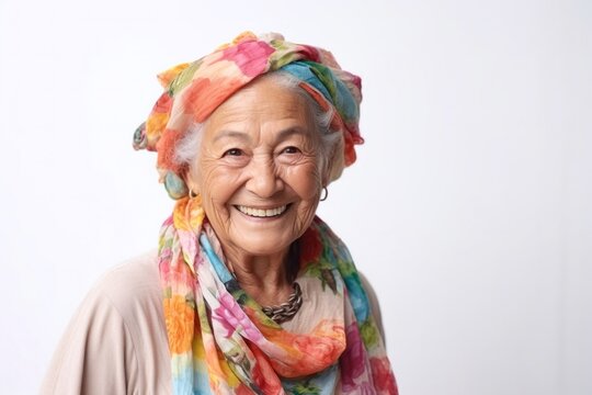 medium shot portrait of a confident Mexican woman in her 90s wearing a foulard against a white background