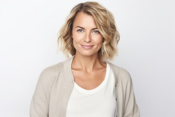 medium shot portrait of a confident Polish woman in her 30s wearing a chic cardigan against a white background