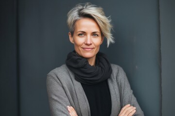medium shot portrait of a confident Polish woman in her 40s wearing a chic cardigan against an abstract background