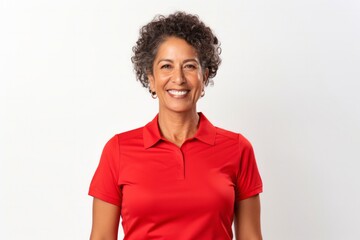 Portrait of a confident Mexican woman in her 50s wearing a sporty polo shirt against a white...
