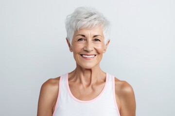medium shot portrait of a confident Polish woman in her 90s wearing a sporty tank top against a white background