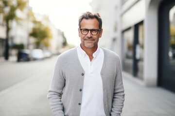 Obraz premium Portrait of a confident Polish man in his 40s wearing a chic cardigan against a white background